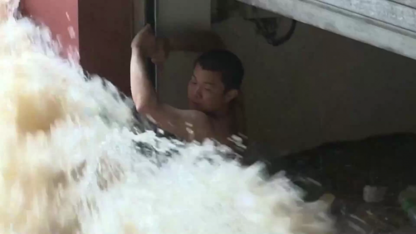Man Rescued In Flooded Underground Parking Lot In South China