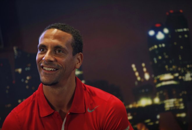 Former Manchester United player Rio Ferdinand smiles as he meets the media during a promotional event
