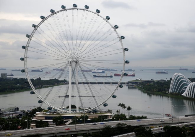 Vessels are pictured behind the Singapore Flyer observatory wheel in the southern coast of Singapore