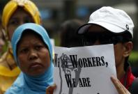 Domestic helpers rally in support of an Indonesian maid who was tortured by her employers