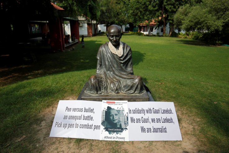 Placards are placed in front of state of Gandhi during protest against killing of Gauri Lankesh