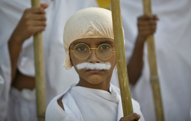 A school boy dressed as Mahatma Gandhi takes part in a march to mark the 143rd birth anniversary of Gandhi in the western Indian city of Ahmedabad October 2, 2012. Mahatma Gandhi, also known as the 