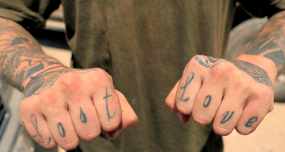 Christian, 28, a former U.S soldier who volunteered for the Syrian Democratic Forces to fight against Islamic state in Raqqa as a sniper shows his tattoos in Harqala, west of Raqqa, Syria August 8, 2017. REUTERS/Zohra Bensemra