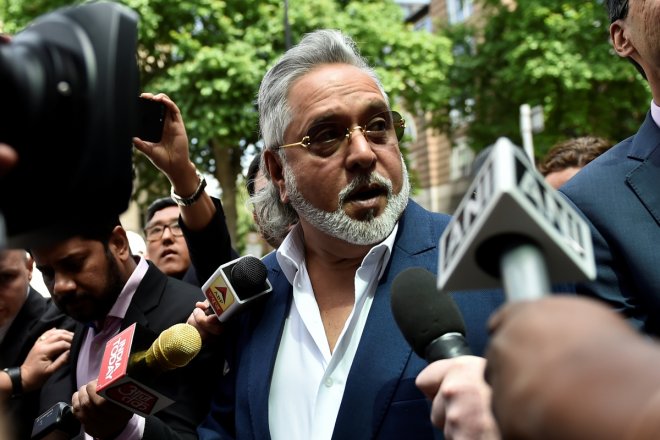 Force India co-owner, Vijay Mallya, talks outside Westminster Magistrates, in central London