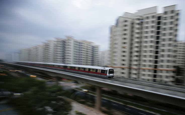 A MRT train travels along a track in a neighbourhood in Singapore