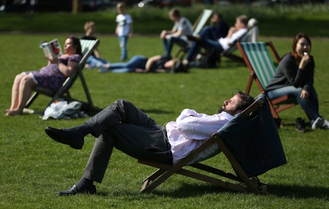 People relax in the sunshine on a warm day in London, Britain May 4, 2016.