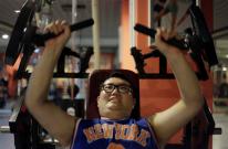 A man lifts weight as part of his training during a six-week programme in an exercise room at the Bodyworks weight loss campus in Beijing August 26, 2011. Participants at the Bodyworks weight loss campus come from across China, paying 30,000 yuan ($4,696)