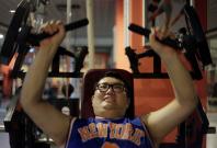 A man lifts weight as part of his training during a six-week programme in an exercise room at the Bodyworks weight loss campus in Beijing August 26, 2011. Participants at the Bodyworks weight loss campus come from across China, paying 30,000 yuan ($4,696)