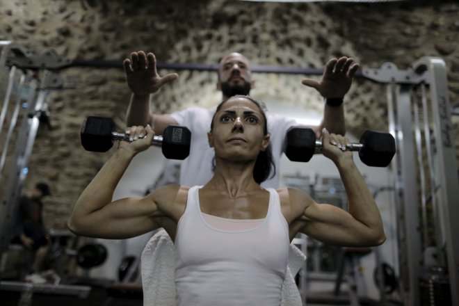 Palestinian bodybuilder Anoush Belian trains with her coach Basil Saed in a gym in Jerusalem's Old City August 20, 2015. Belian on Saturday became the first Palestinian female bodybuilder to participate and win an Israeli competition. Belian won the Miss 