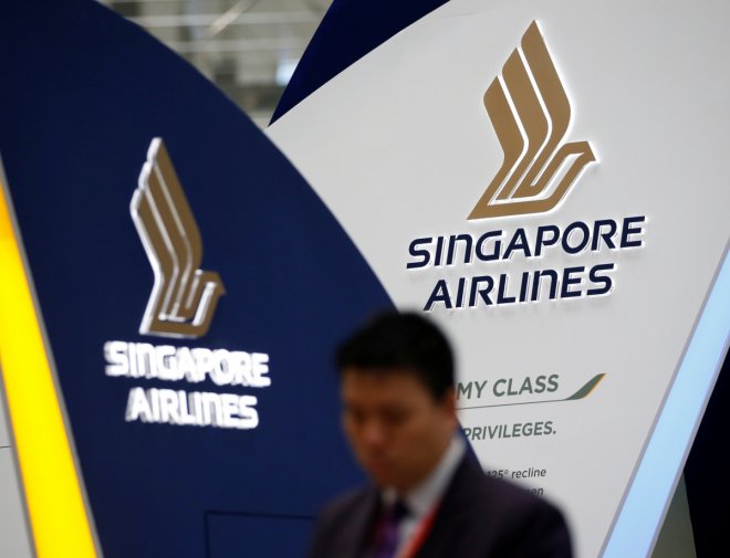 A man walks past a Singapore Airlines signage at Changi Airport in Singapore