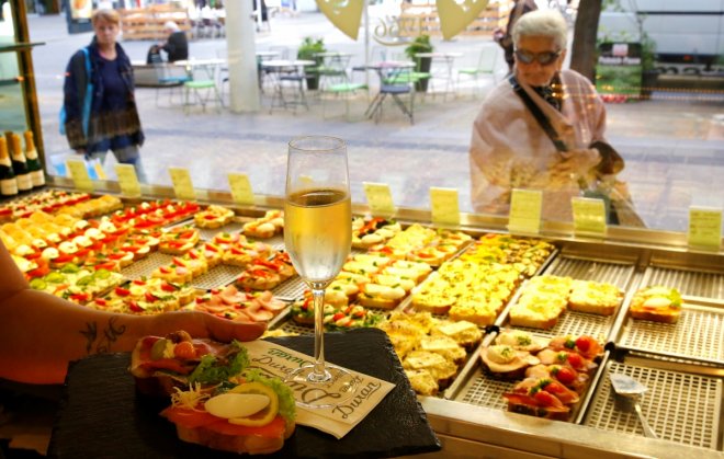 A waiter serves a sandwich and a glass of champaign in the Duran sandwich shop in Vienna