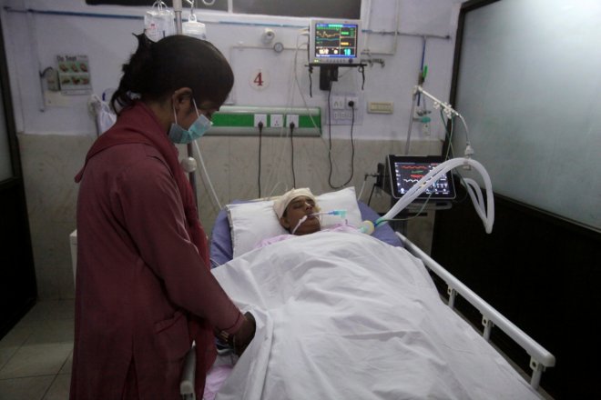 A nurse cares for a woman injured during shelling along the disputed border between Pakistan and India