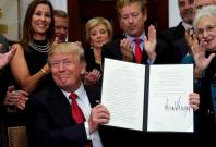U.S. President Donald Trump smiles after signing an Executive Order to make it easier for Americans to buy bare-bone health insurance plans and circumvent Obamacare rules at the White House in Washington, U.S.