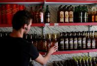 A liquor store owner checks bottles of alcohol at his store in the town of Qaraqosh A liquor store owner checks bottles of alcohol at his store in the town of Qaraqosh