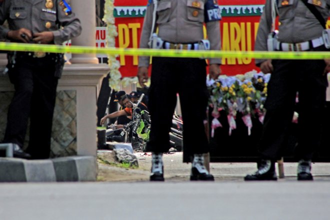 Police secure the scene at a police station following an attack in Solo, Central Java, Indonesia