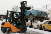 Forklift lifting a car