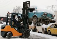 Forklift lifting a car