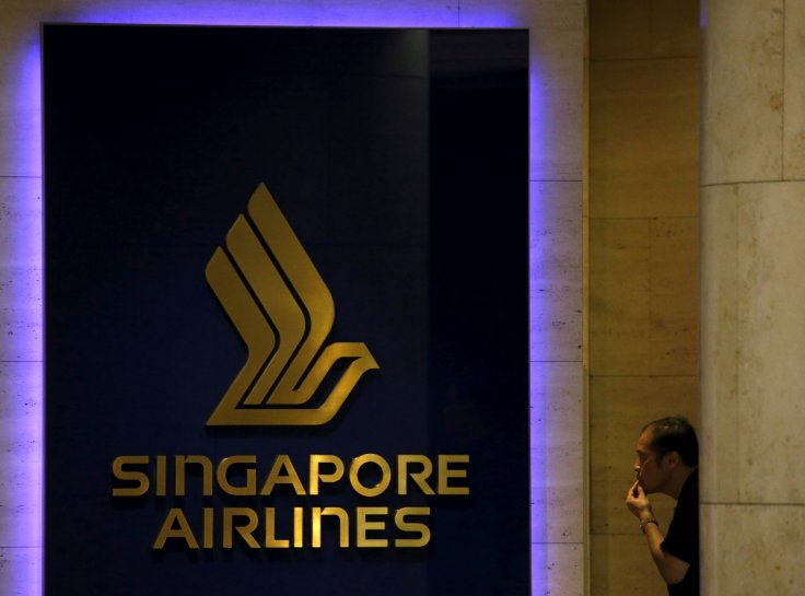 FILE PHOTO: A man looks at a Singapore Airlines (SIA) signage outside an SIA service center in Singapore February 10, 2016.
