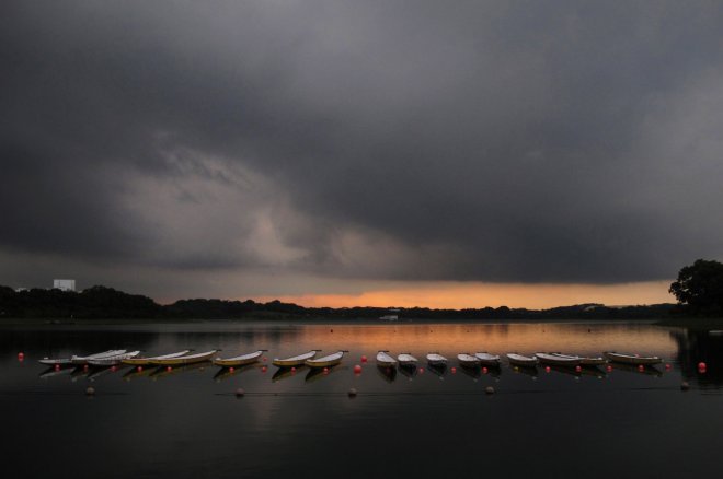 Canoes are seen moored at Bedok Reservoir in Singapore, at sunset