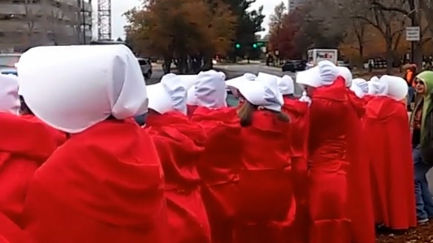 Mike Pence greeted by Handsmaids in Denver