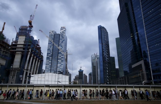 SingaporeCommuters walk to the train station during evening rush hour in the financial district of Singapore SingaporeCommuters walk to the train station during evening rush hour in the financial district of Singapore