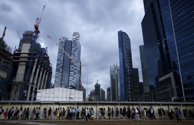 SingaporeCommuters walk to the train station during evening rush hour in the financial district of Singapore