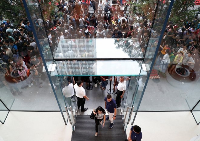 People queue to buy iPhone X during its launch at the Apple store in Singapore