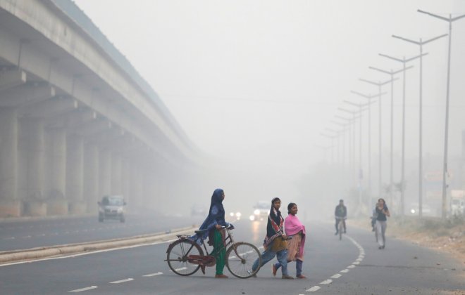 People cross the road in Delhi