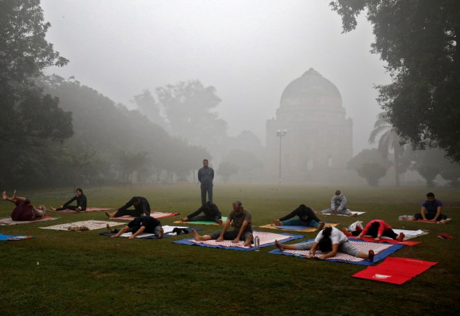 People exercise in a park on a smoggy morning in New Delhi.