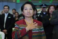 Outgoing Philippine President Gloria Macapagal Arroyo stands on attention