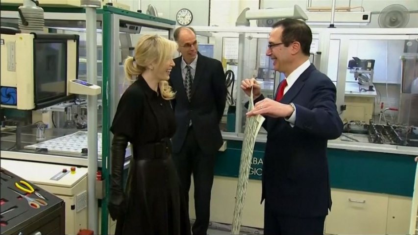 US Treasury Secretary Steve Mnuchin and wife Louise Linton pose for photos with dollar bills