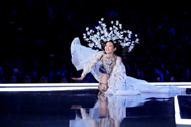 Ming Xi falls as she presents a creation during the 2017 Victoria's Secret Fashion Show in Shanghai