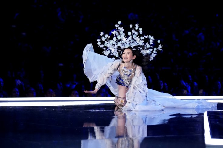 Model Ming Xi falls as she presents a creation during the 2017 Victoria's Secret Fashion Show in Shanghai, China