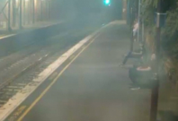 Dramatic footage shows woman pulled away from oncoming train with seconds to spare