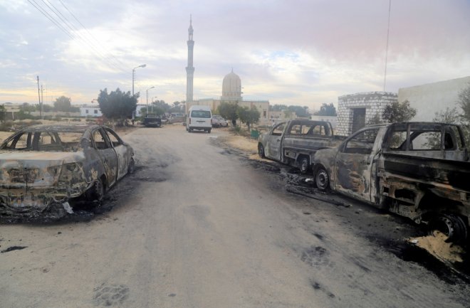 Damaged vehicles are seen after a bomb exploded at Al Rawdah mosque