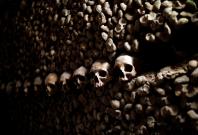 Human skulls and bones which are stacked in the ossuary room in the catacombs of Paris