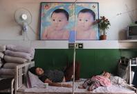 File photo of an ethnic Uighur woman on a drip at a hospital in Shaya county of Aksu