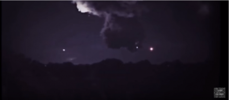 UFOs near a thunder cloud 