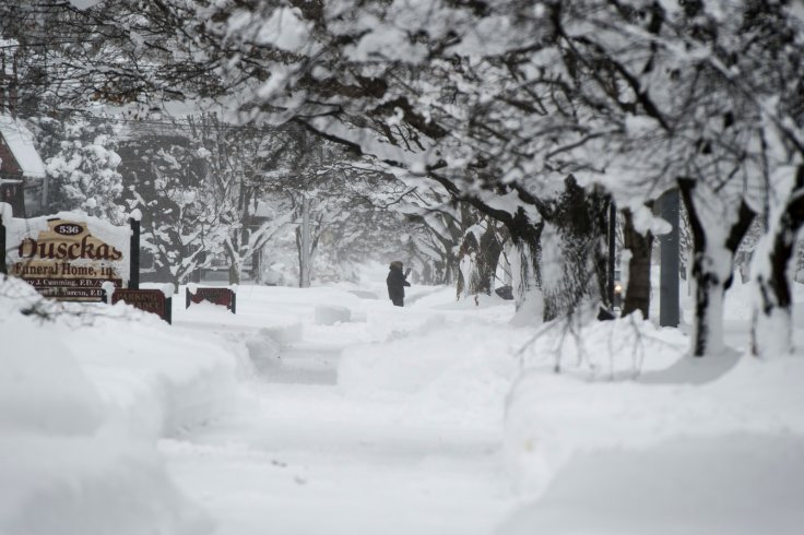 A resident seen attempting to walk through the snow on 10th street after two days of record-breaking snowfall in Erie, Pennsylvania, U.S