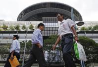 People walk past the Supreme Court in Singapore People walk past the Supreme Court in Singapore