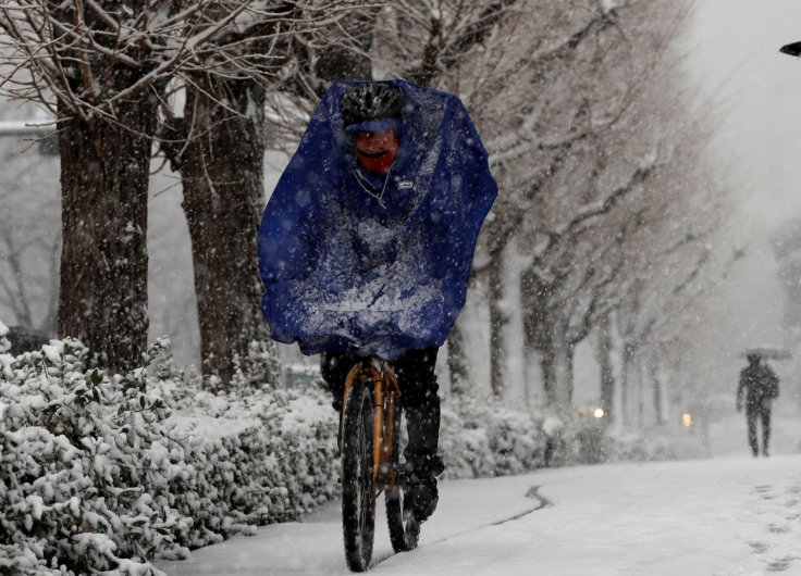 A man rides a bicycle in the heavy snow in Tokyo