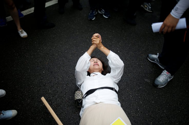 A Christian woman who opposes homosexuality tries to stop a march during the Korea Queer Culture Festival 2016 in central Seoul, South Korea, June 11, 2016.