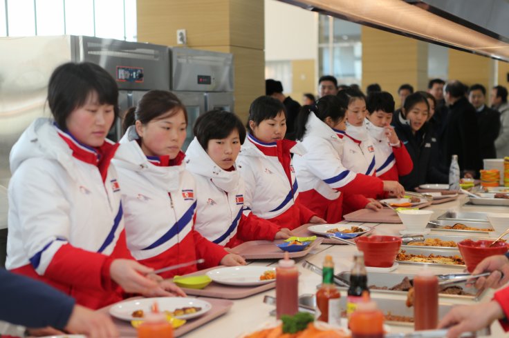 North Korea women's ice hockey athletes stand in a line at a dining hall at the Jincheon National Training Centre in Jincheon