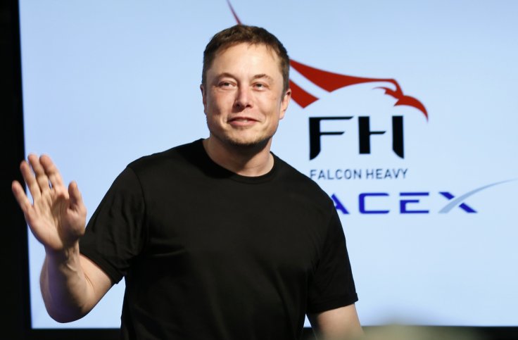 SpaceX founder Elon Musk waves at a press conference following the first launch of a SpaceX Falcon Heavy rocket at the Kennedy Space Center
