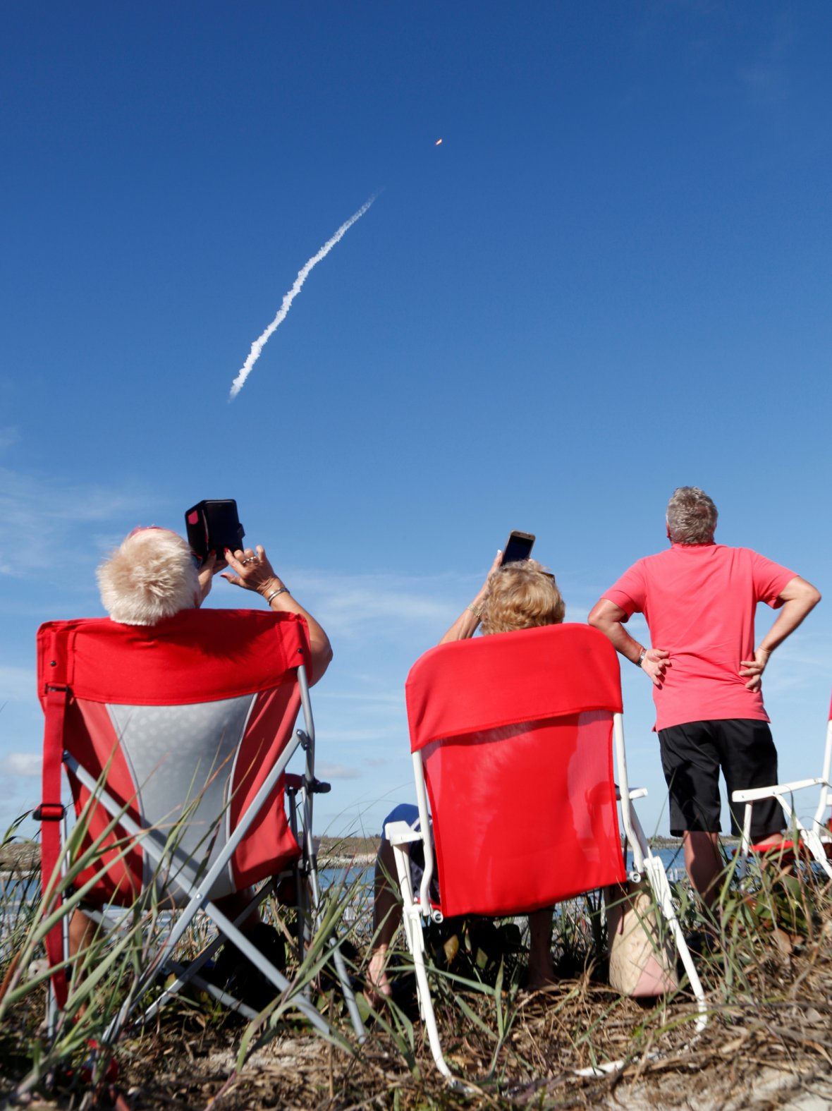 Spectators watch SpaceX's first Falcon Heavy rocket launches from the Kennedy Space Center in Florida