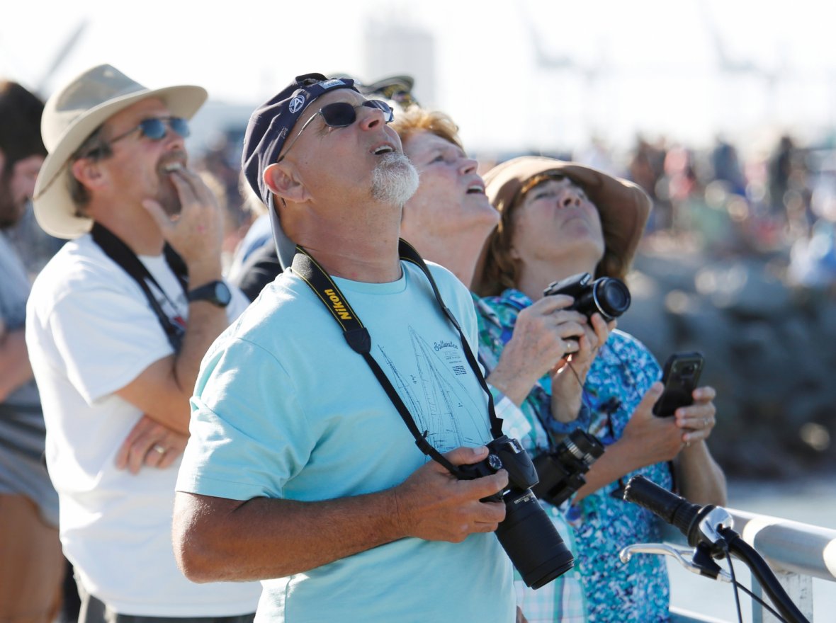 Spectators watch SpaceX's first Falcon Heavy rocket launches from the Kennedy Space Center in Florida