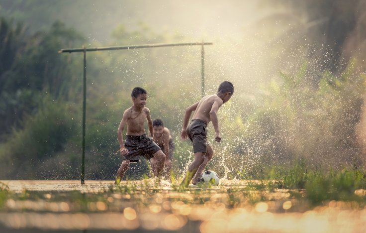 School children playing a ball games as it helps them to develop the stronger bone and also can increased their strength  and improved bone health. 