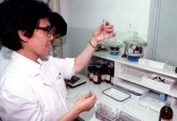 Lab technician checking sample in Beijing. Lab technician checking sample in Beijing.