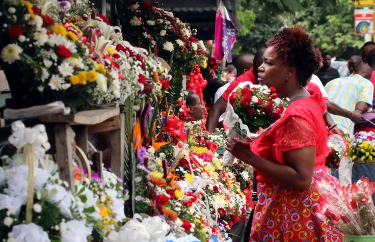 A woman buys flowers at a market on Valentine's Day in Harare