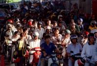 Malaysian motorcyclists wait to go through customs at the Malaysia - Singapore border Malaysian motorcyclists wait to go through customs at the Malaysia - Singapore border